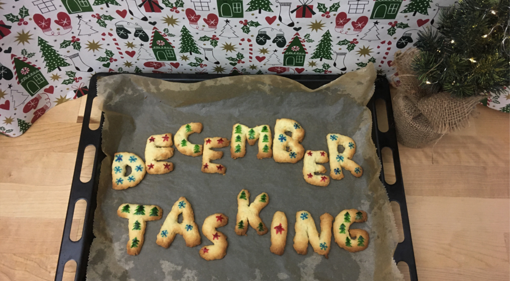 On the header picture are letter shaped biscuits spelling: December Tasking. They are decorated with snowflakes, stars or christmastrees. D = 6 flakes, E = 4 stars, C = 3 trees, M = 7 trees, B = 3 flakes, R = 5 flakes, T = 5 trees, A = 3 flakes, S = 3 stars, K = 4 trees, I = 1 star, N = 2 flakes, G = 5 trees