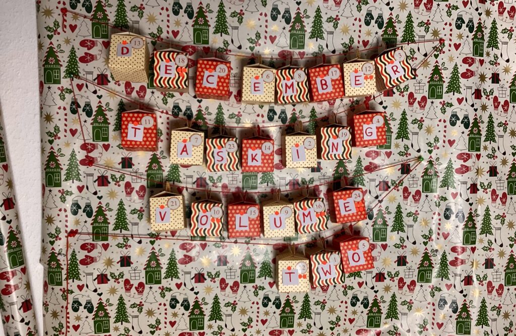 Photo of 24 little boxes with numbers and letters on them.